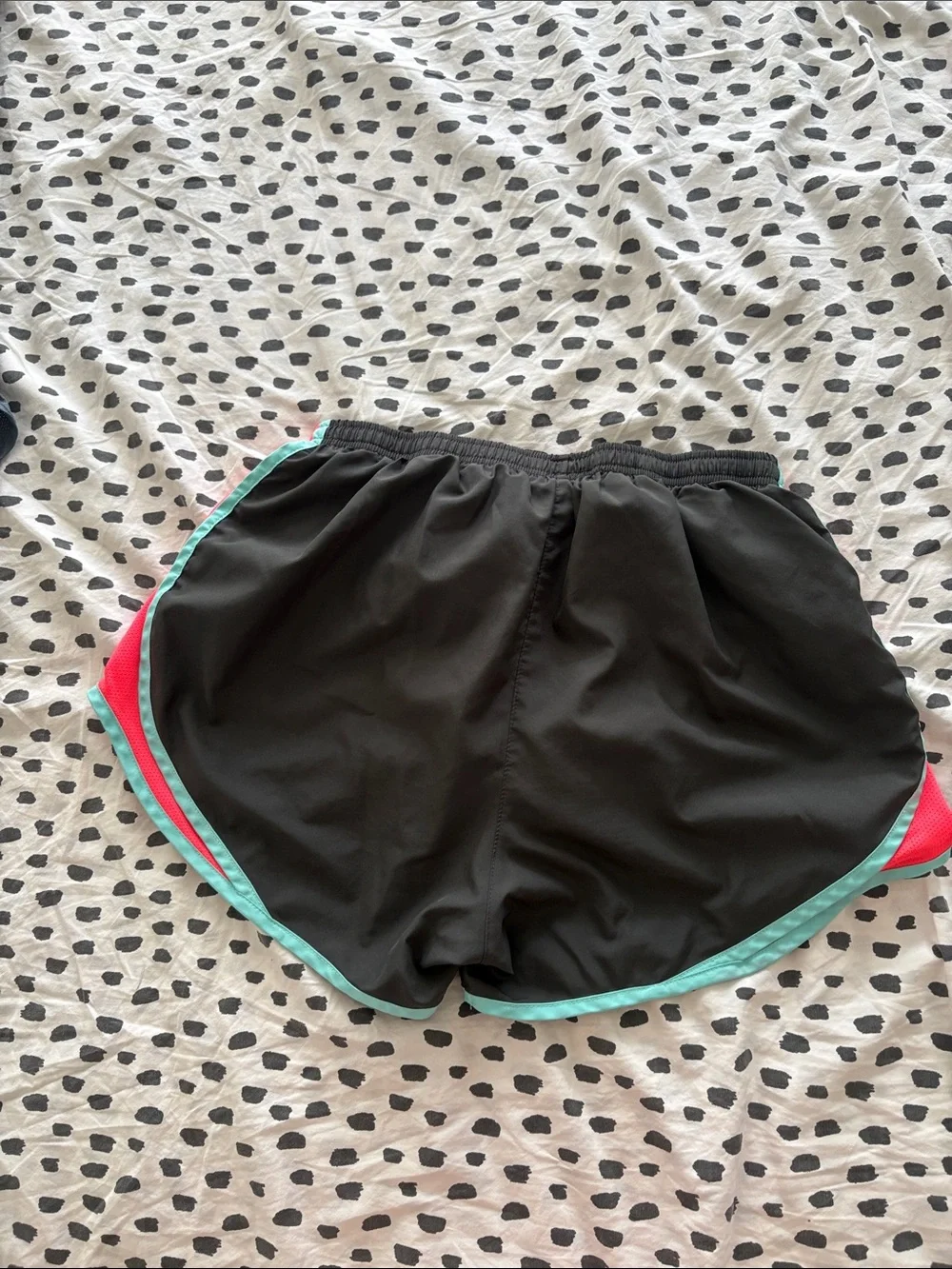 Nike Black Athletic Shorts with Teal Trim and Coral Side Panels